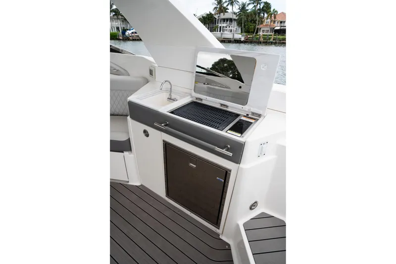 Slide: The Image of Outdoor kitchen on 2022 Sea Ray SLX 350 Outboard boat with grill and sink. - 15