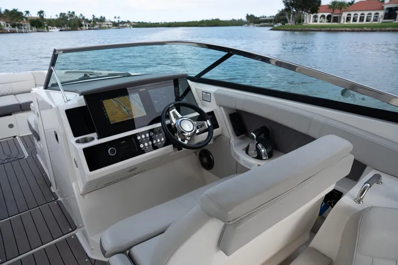 Slide: The Image of 2022 Sea Ray SLX 350 Outboard helm with modern controls and navigation display. - 21