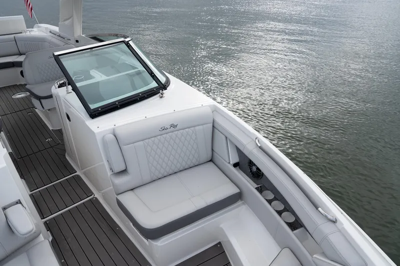 Slide: The Image of 2022 Sea Ray SLX 350 Outboard boat interior with luxurious seating on calm water. - 27
