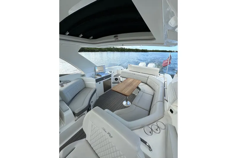 Slide: The Image of Luxurious 2022 Sea Ray SLX 350 Outboard boat interior with elegant seating and scenic water view. - 3