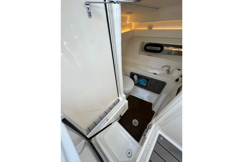 Slide: The Image of 2022 Sea Ray SLX 350 Outboard boat interior bathroom with sink and toilet. - 9
