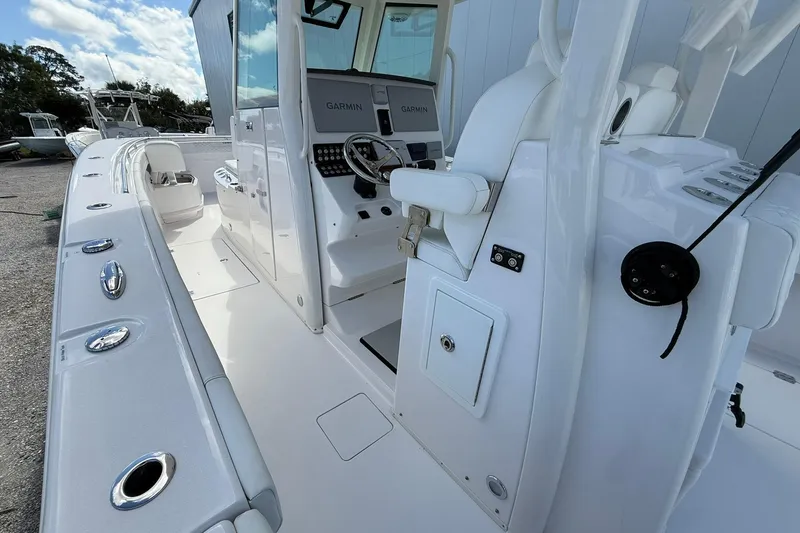 Slide: The Image of 2024 Caymas 30 CT boat interior with Garmin navigation, sleek white design, and modern controls. - 11