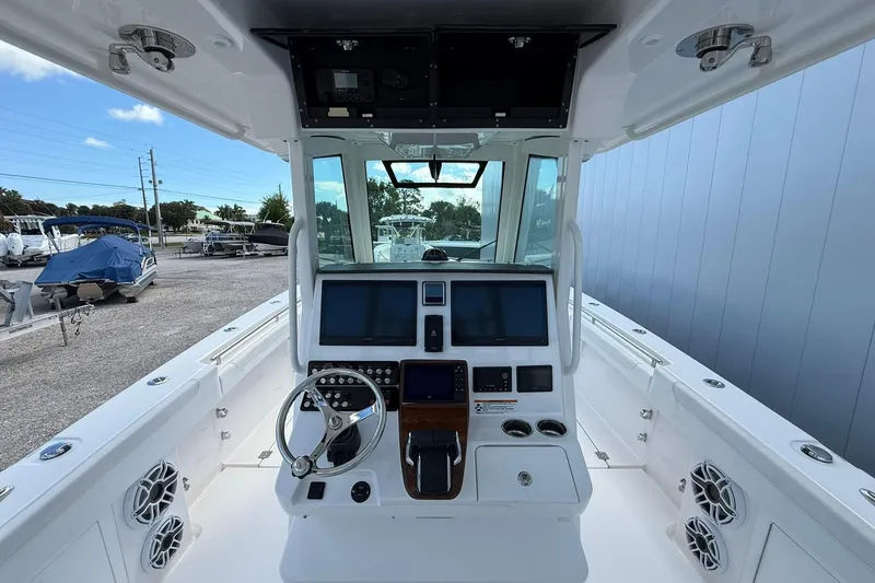 Slide: The Image of 2024 Caymas 30 CT boat cockpit with modern controls and navigation screens. - 13