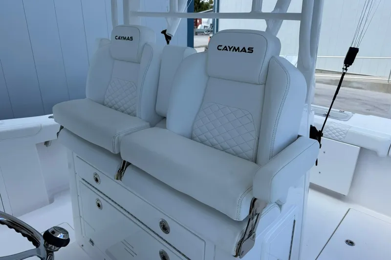 Slide: The Image of 2024 Caymas 30 CT boat with luxurious white seating and embroidered branding. - 17