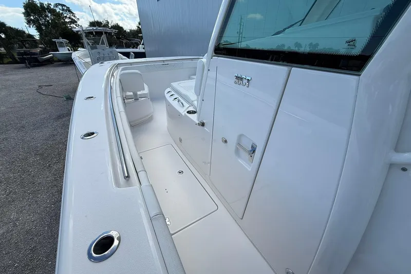 Slide: The Image of 2024 Caymas 30 CT boat deck with seating and storage compartments. - 19