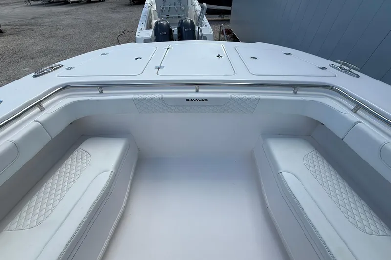 Slide: The Image of 2024 Caymas 30 CT boat interior with cushioned seating and storage compartments. - 22