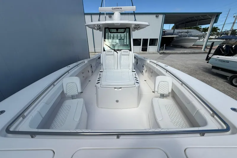 Slide: The Image of 2024 Caymas 30 CT boat interior with white seating and Garmin equipment. - 24