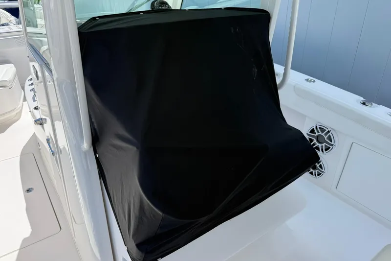 Slide: The Image of 2024 Caymas 30 CT boat interior with covered console and white seating. - 29