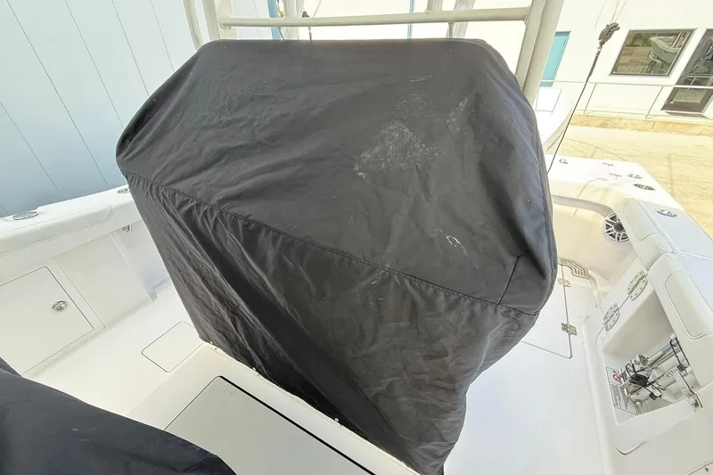 Slide: The Image of 2024 Caymas 30 CT boat interior with covered console, showcasing sleek white deck design. - 32