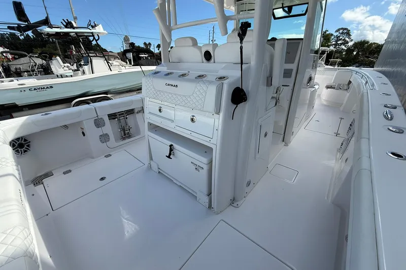Slide: The Image of 2024 Caymas 30 CT boat interior with white seating and storage compartments. - 7