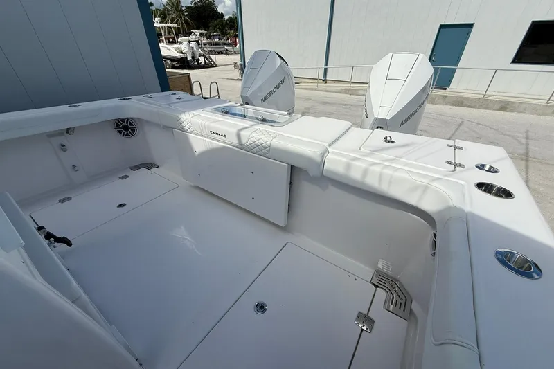 Slide: The Image of 2024 Caymas 30 CT boat interior with Mercury engines, featuring spacious seating and storage. - 9
