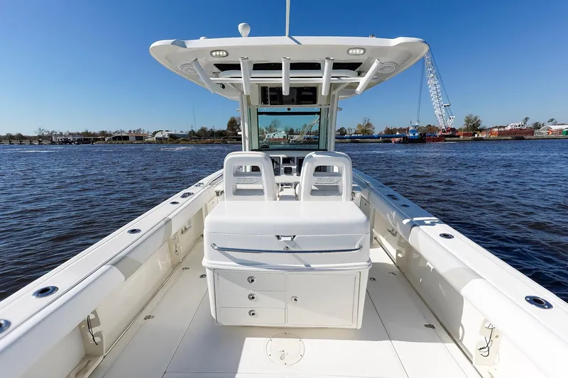 Slide: The Image of 2013 Boston Whaler 320 Outrage boat on calm water, clear sky background. - 14