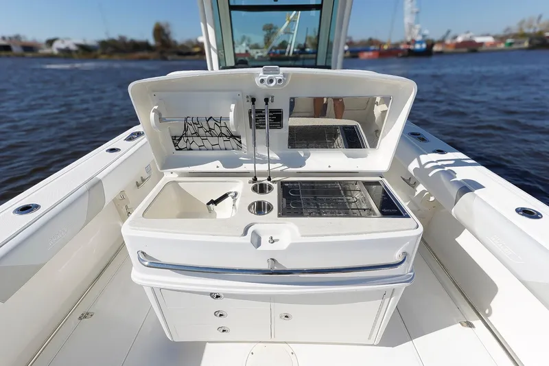 Slide: The Image of 2013 Boston Whaler 320 Outrage boat interior with open storage compartments. - 15