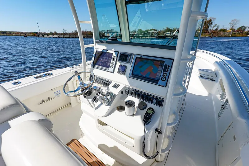 Slide: The Image of 2013 Boston Whaler 320 Outrage boat cockpit with modern navigation equipment. - 18