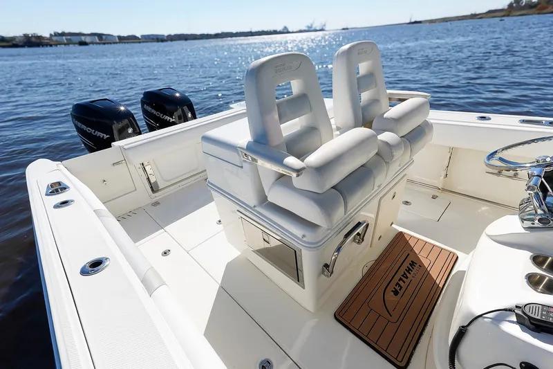 Slide: The Image of 2013 Boston Whaler 320 Outrage boat interior with dual Mercury engines on a sunny day. - 19