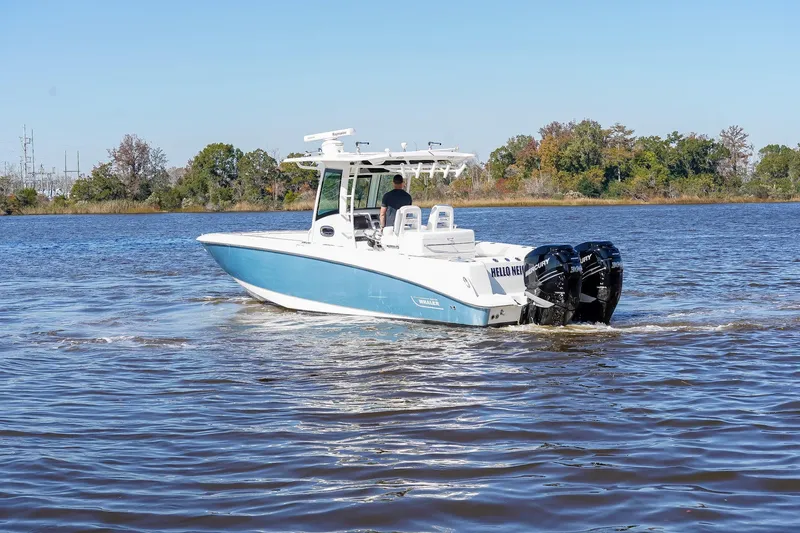 Slide: The Image of 2013 Boston Whaler 320 Outrage boat cruising on a calm river. - 2