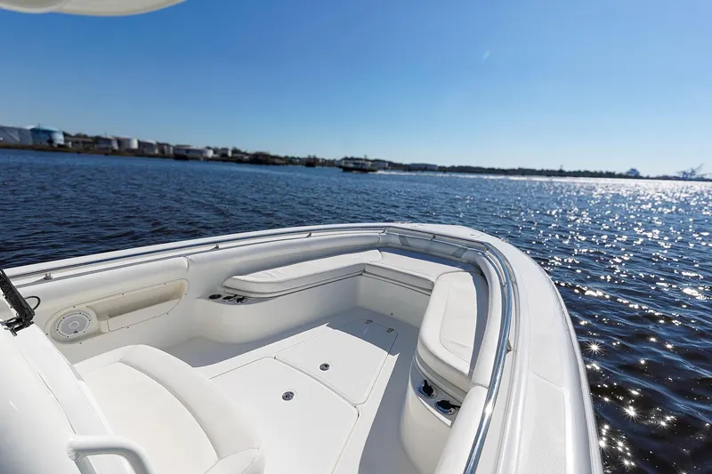 Slide: The Image of 2013 Boston Whaler 320 Outrage boat on calm water under clear blue sky. - 22
