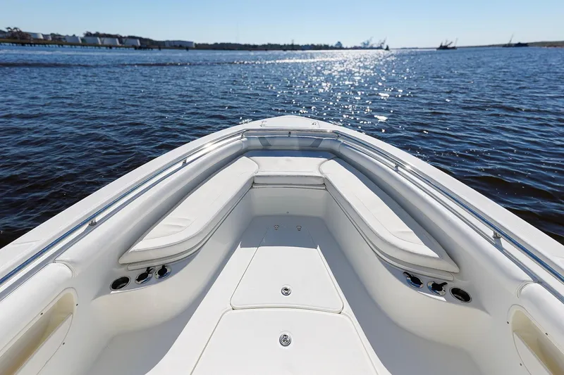 Slide: The Image of 2013 Boston Whaler 320 Outrage boat on calm water, featuring spacious seating area. - 23