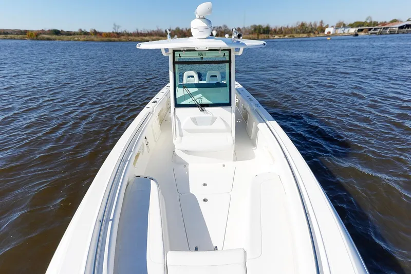 Slide: The Image of 2013 Boston Whaler 320 Outrage boat on calm water, showcasing spacious deck. - 25