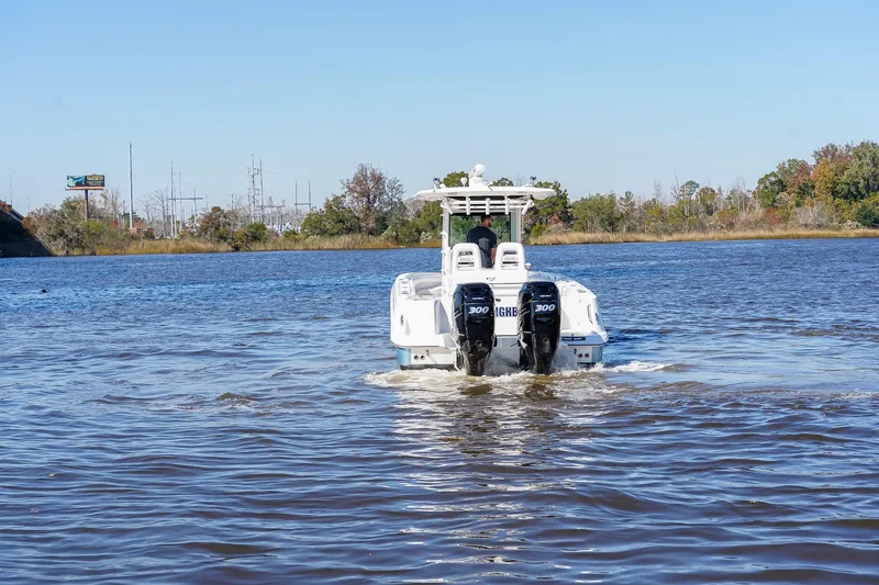 Slide: The Image of 2013 Boston Whaler 320 Outrage boat cruising on a calm river. - 3