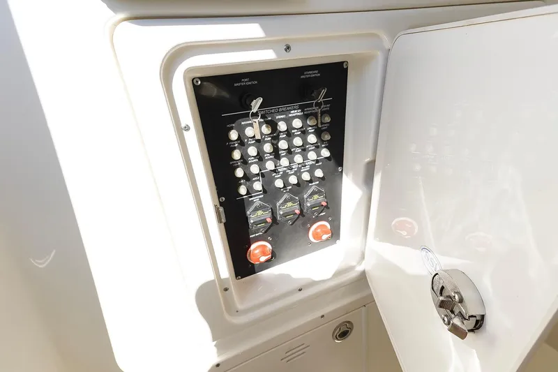 Slide: The Image of Control panel inside 2013 Boston Whaler 320 Outrage boat, featuring switches and circuit breakers. - 30
