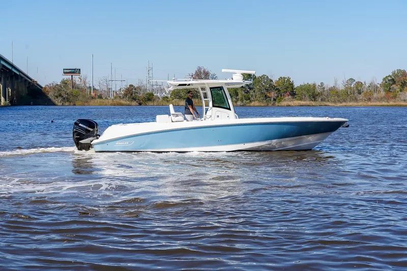 Slide: The Image of 2013 Boston Whaler 320 Outrage boat cruising on a calm river. - 5