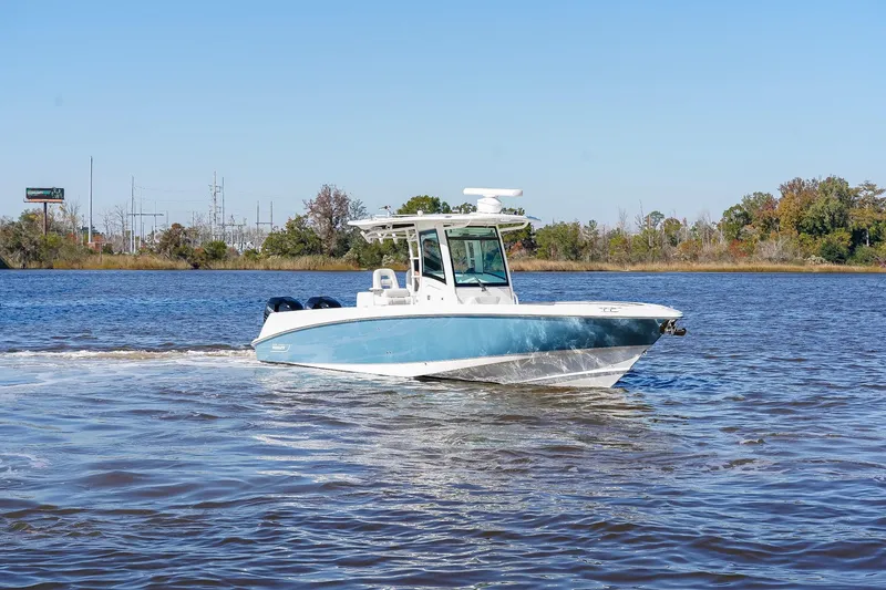 Slide: The Image of 2013 Boston Whaler 320 Outrage cruising on a calm river under clear skies. - 6
