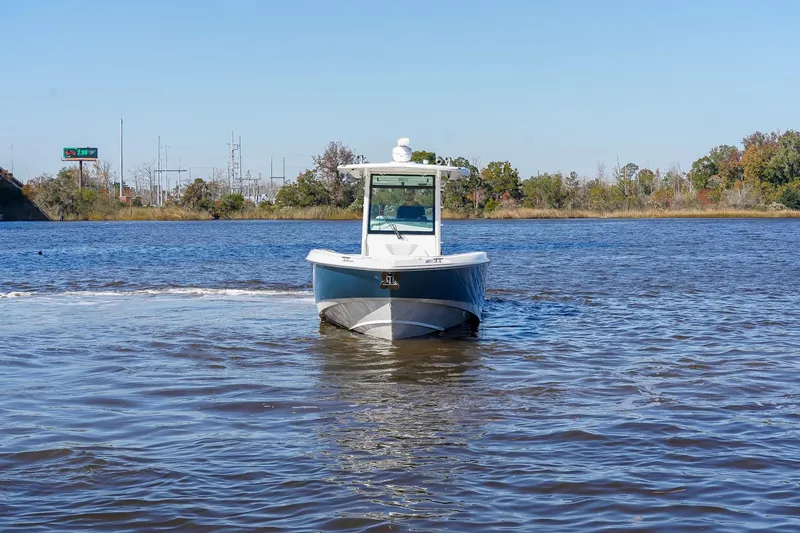 Slide: The Image of 2013 Boston Whaler 320 Outrage boat cruising on a calm river. - 7