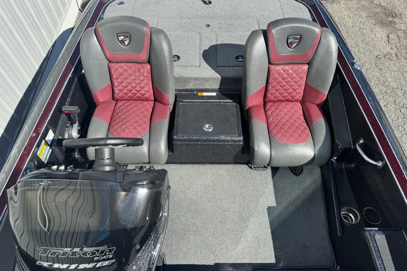 Slide: The Image of 2016 Triton 179 TrX boat interior with red and gray seats, steering console visible. - 10