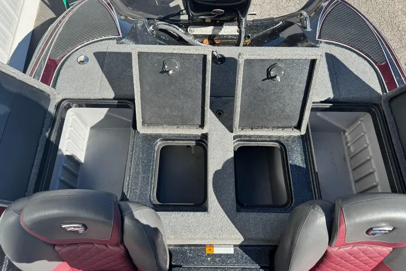 Slide: The Image of 2016 Triton 179 TrX boat interior with open storage compartments and seating. - 12