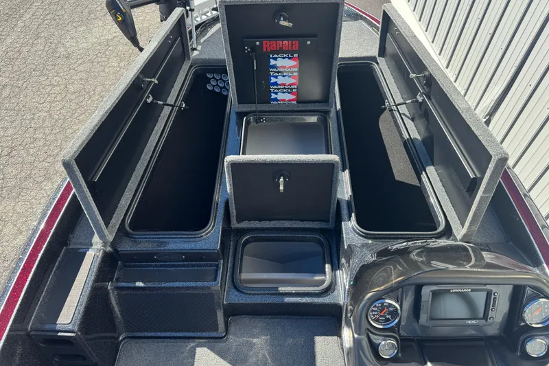 Slide: The Image of 2016 Triton 179 TrX boat storage compartments open, showcasing organized tackle storage. - 13