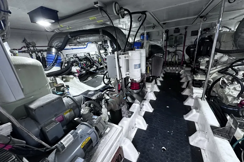 Slide: The Image of Engine room of 2004 McKinna 57 PHMY Widebody yacht, showcasing complex machinery and stabilization systems. - 106