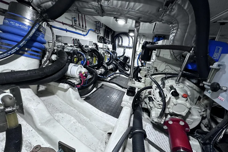 Slide: The Image of Engine room of a 2004 McKinna 57 PHMY Widebody yacht, showcasing complex machinery and stabilization systems. - 111