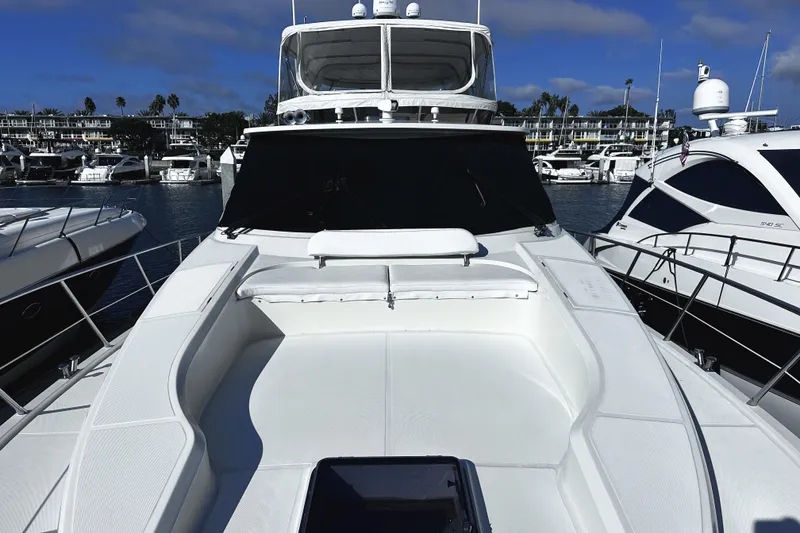 Slide: The Image of 2004 McKinna 57 PHMY Widebody yacht docked in a marina, showcasing sleek design. - 12