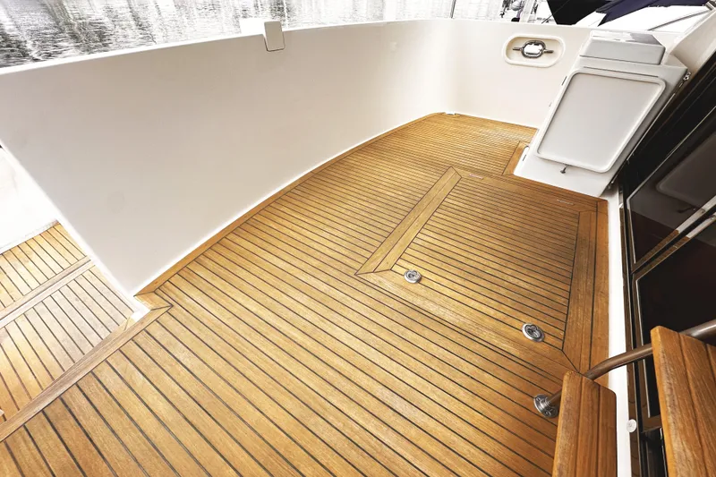 Slide: The Image of Teak deck of 2004 McKinna 57 PHMY Widebody yacht, showcasing elegant wood finish. - 18