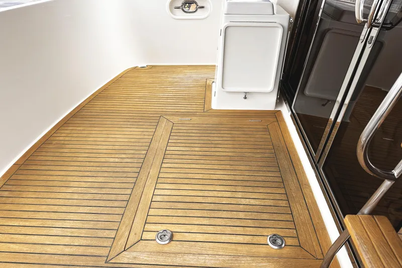 Slide: The Image of Teak deck of 2004 McKinna 57 PHMY Widebody yacht, featuring sleek design and stabilization. - 19