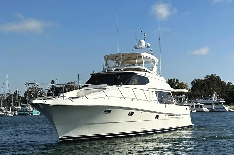 Slide: The Image of 2004 McKinna 57 PHMY Widebody yacht with stabilization, cruising in a marina. - 2