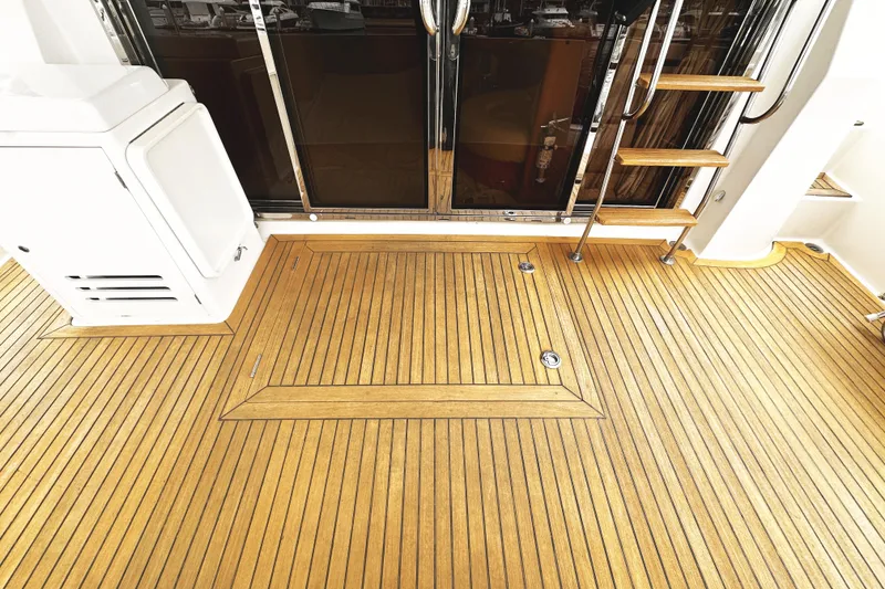 Slide: The Image of Teak deck of 2004 McKinna 57 PHMY Widebody yacht with stairs and sliding glass door. - 20