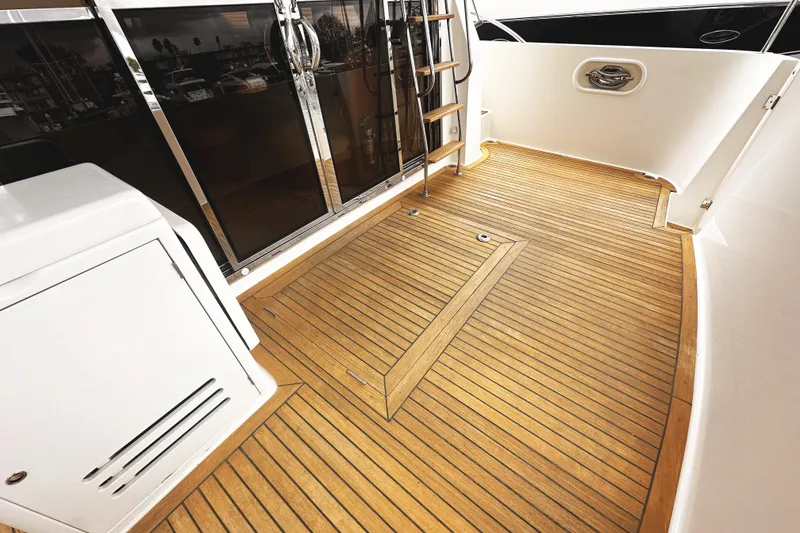 Slide: The Image of 2004 McKinna 57 PHMY yacht deck with teak flooring and stainless steel accents. - 21