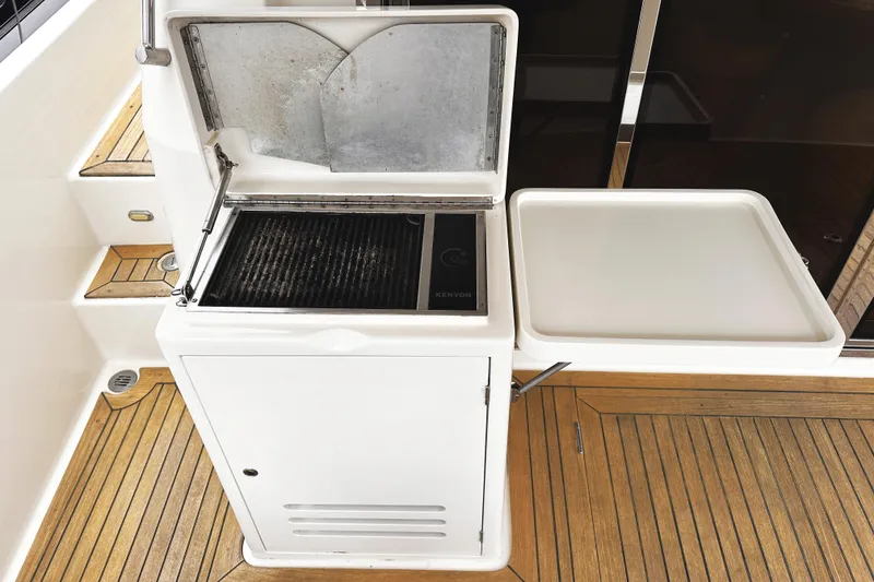 Slide: The Image of Outdoor grill and prep station on 2004 McKinna 57 PHMY yacht with teak flooring. - 24
