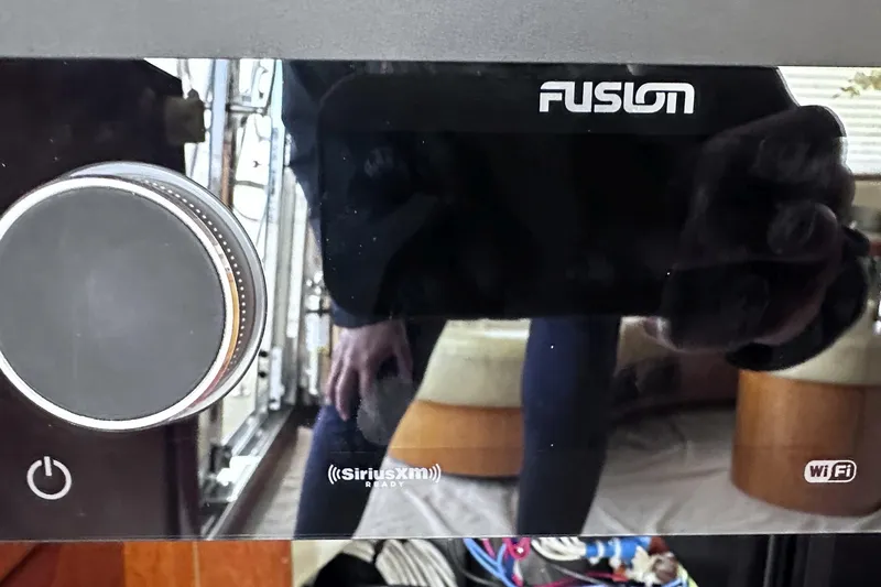 Slide: The Image of Fusion audio system on a 2004 McKinna 57 PHMY yacht, featuring SiriusXM and WiFi capabilities. - 42