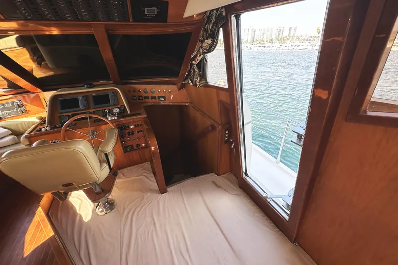 Slide: The Image of 2004 McKinna 57 PHMY yacht helm with wooden interior and ocean view. - 48