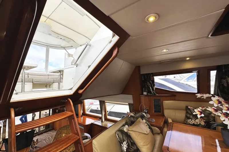 Slide: The Image of Interior of 2004 McKinna 57 PHMY yacht, featuring luxurious seating and elegant decor. - 49