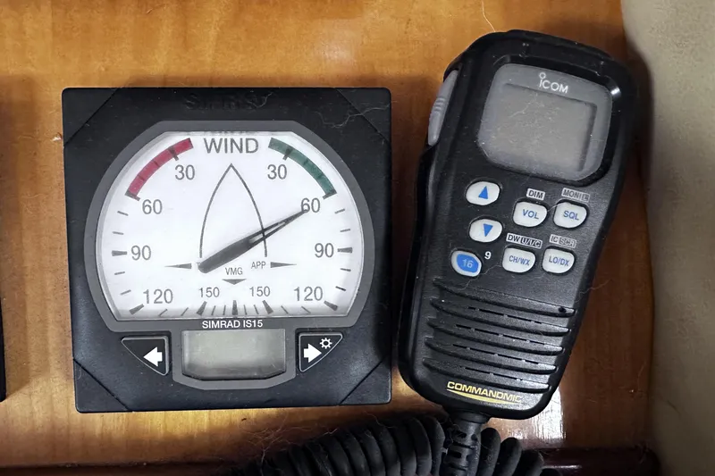Slide: The Image of Wind gauge and radio on 2004 McKinna 57 PHMY Widebody yacht dashboard. - 57
