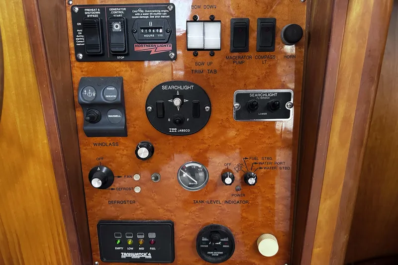 Slide: The Image of Control panel of a 2004 McKinna 57 PHMY Widebody yacht with various switches and indicators. - 60