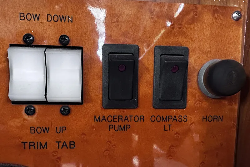 Slide: The Image of Control panel of a 2004 McKinna 57 PHMY yacht with switches and labels. - 62