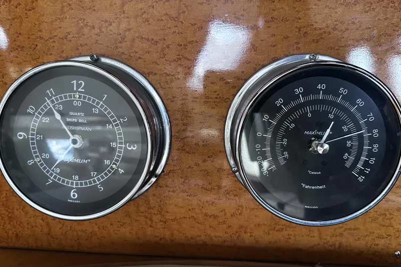 Slide: The Image of Analog clock and thermometer on McKinna 57 PHMY Widebody yacht dashboard, 2004 model. - 67