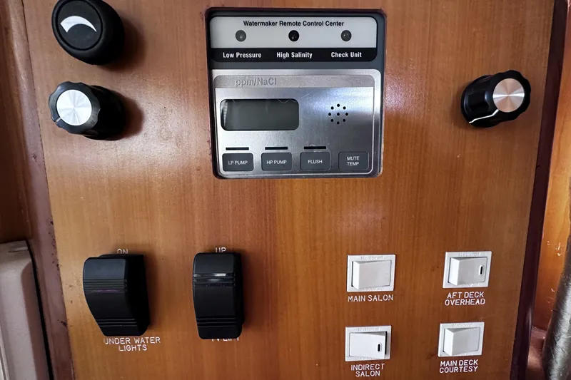 Slide: The Image of Control panel of a 2004 McKinna 57 PHMY Widebody yacht with various switches and dials. - 70