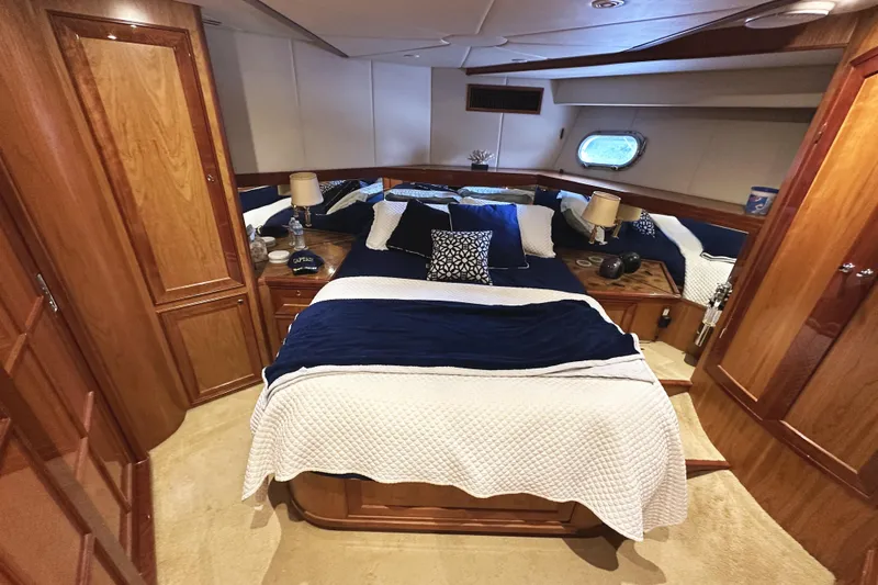 Slide: The Image of Luxurious cabin interior of 2004 McKinna 57 PHMY yacht with elegant bedding and wood finishes. - 73