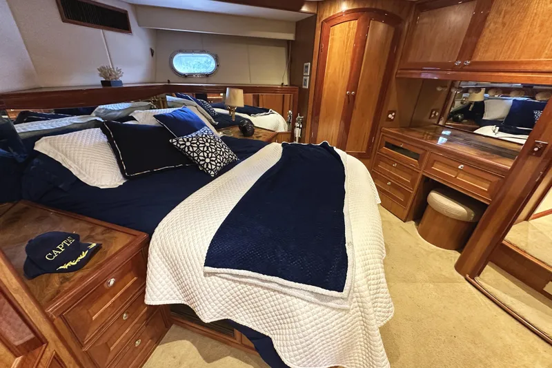 Slide: The Image of Luxurious 2004 McKinna 57 PHMY yacht bedroom with elegant wood finishes and cozy bedding. - 75